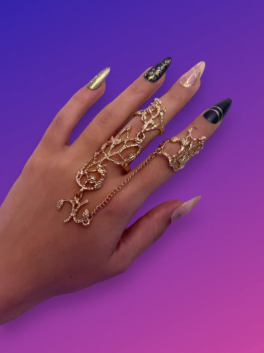 Gold floral mitten chain rings