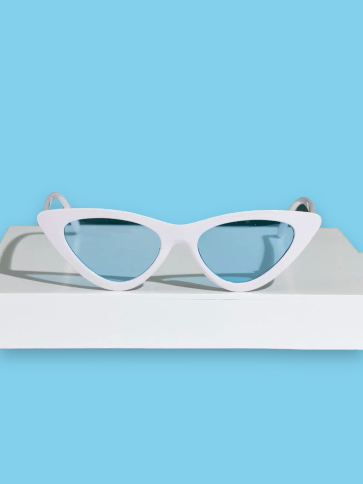 White cat eye fashion sunglasses with blue tinted lenses. Retro style.