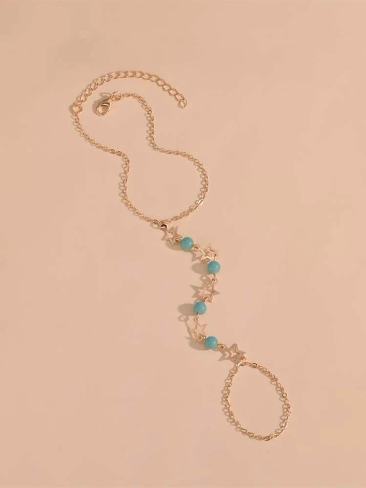 Star anklet with luminous blue beads.