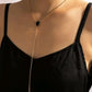 Gold lariat necklace on model