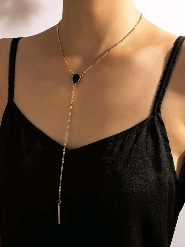 Gold lariat necklace on model