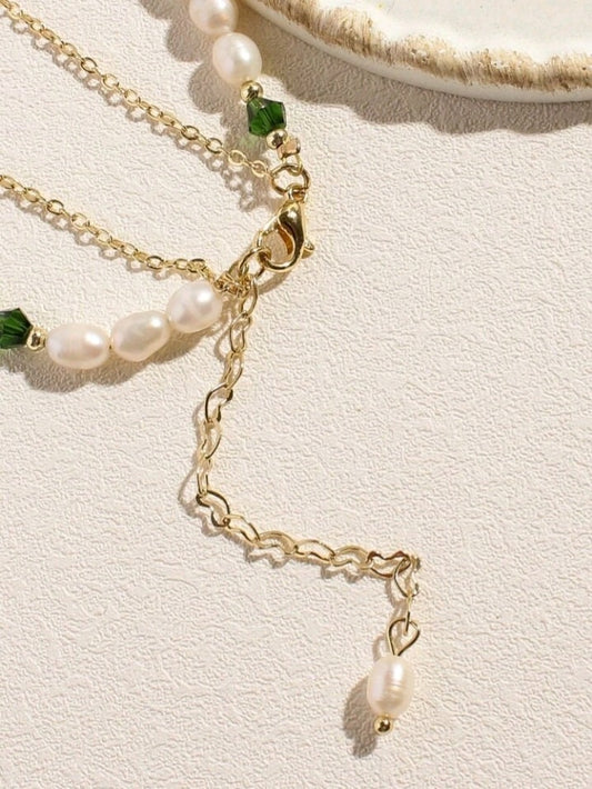 Gold heart detailed extender chain with pearl.