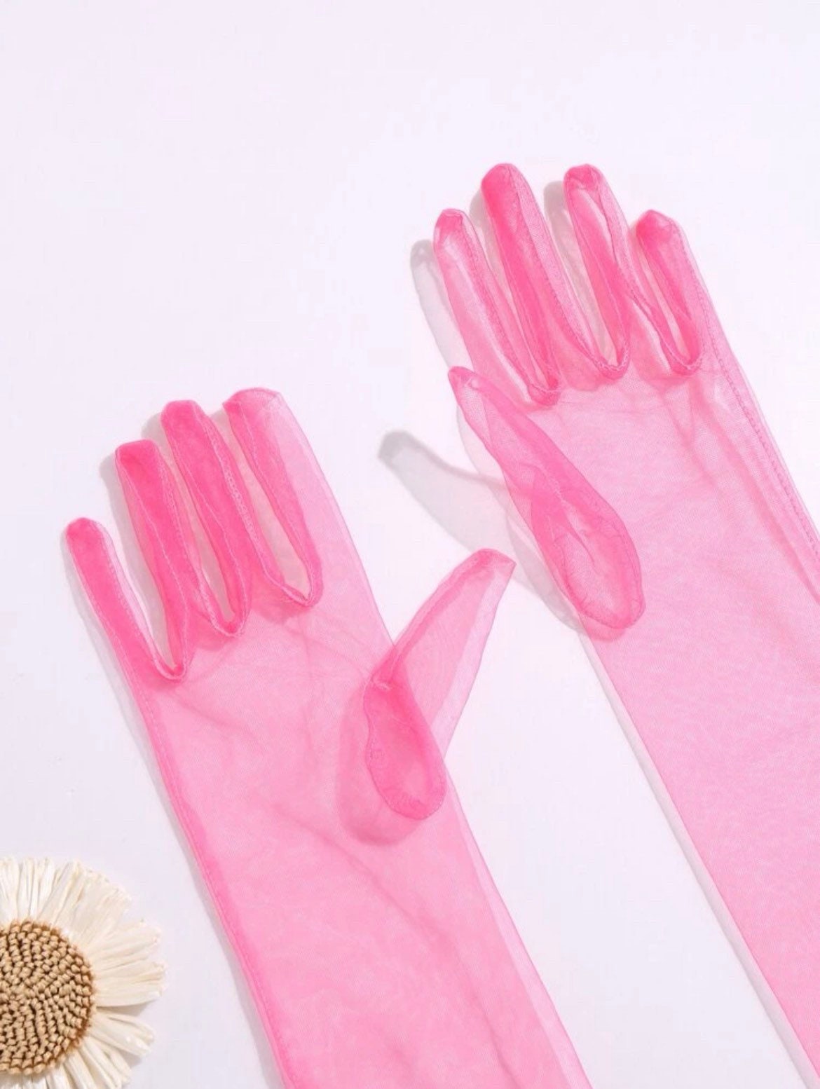 Sheer pink material. Bright pink long gloves.